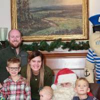 A family of five at the event with Santa & Louie.
